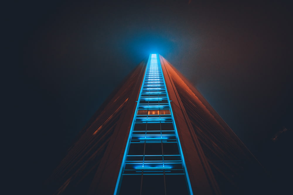 low angle photography of high rise building with lights on