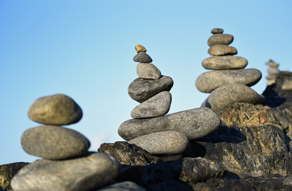 selective focus photography of stacked balance stones