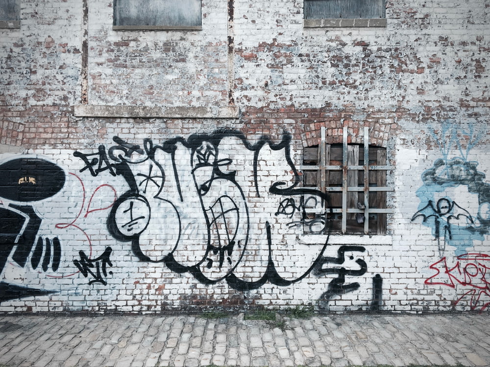 graffiti-painted brick wall