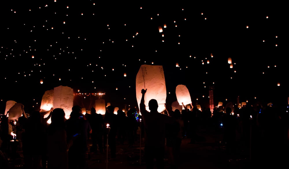 group of people holding lanterns