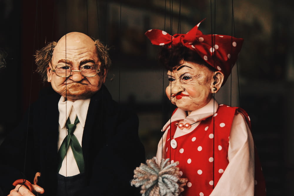 closeup photo of two man and woman puppets