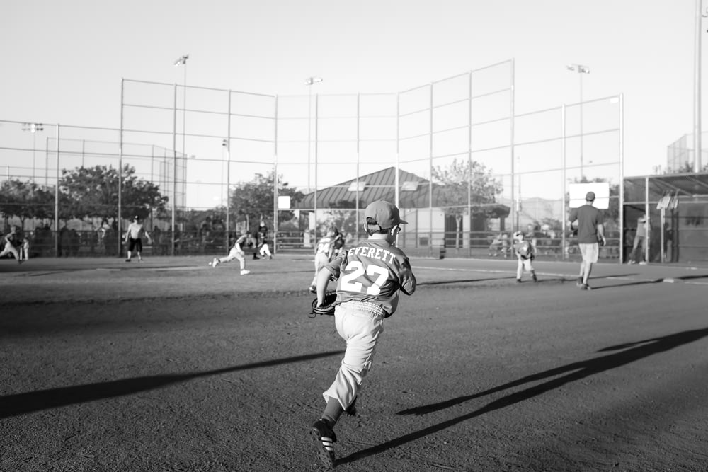 grayscale photo of children playing baseball