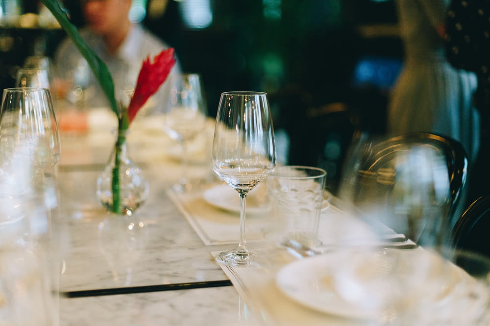 selective-focus photography of wine glass on table