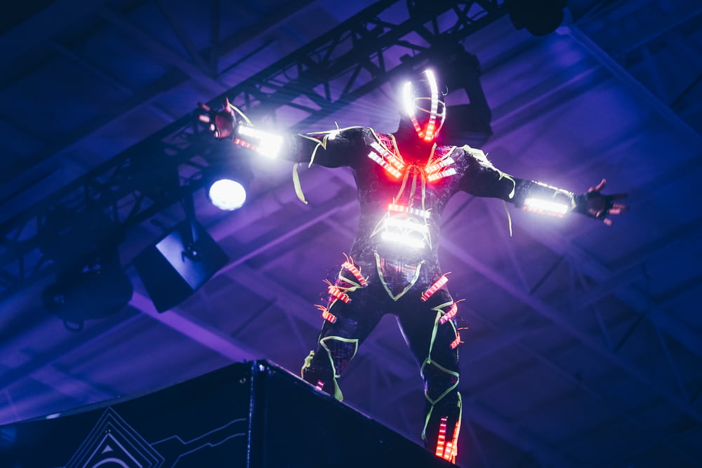 person wearing white and red LED light suit