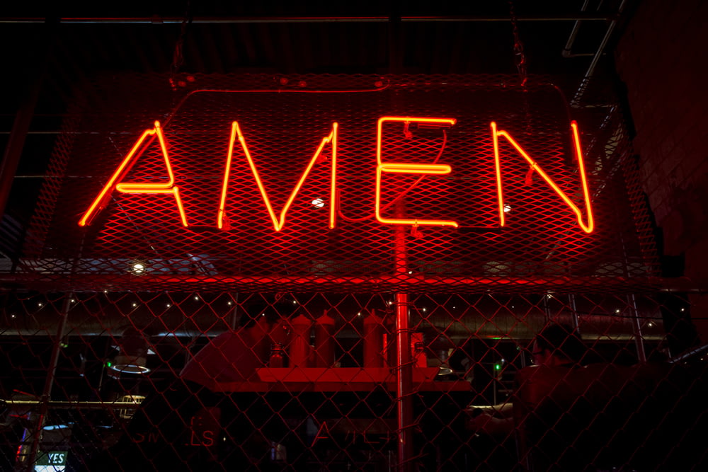 red Amen lit-up signage