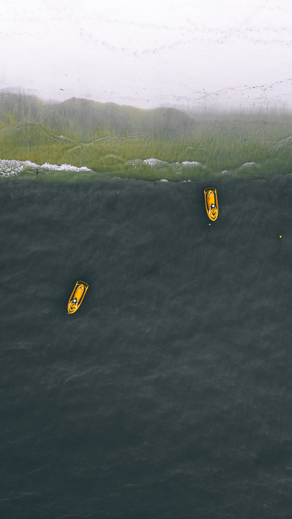 two yellow personal watercraft on water