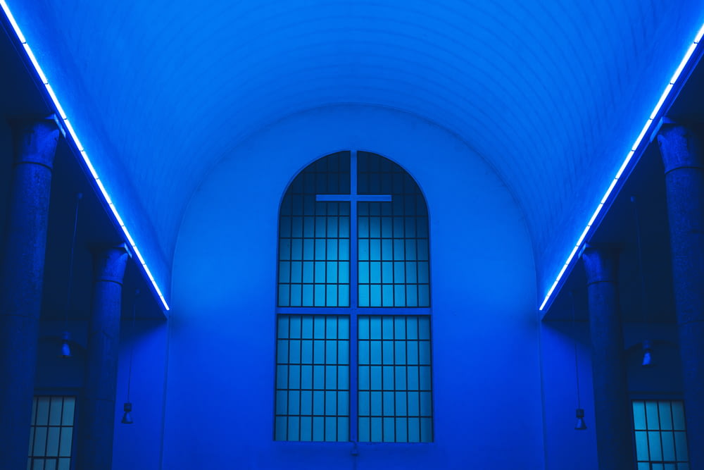 blue lighted ceiling fronting the white cross