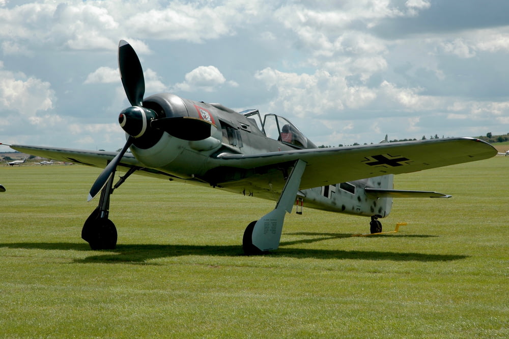 German gray BF 109 plane is parked on the green grass field