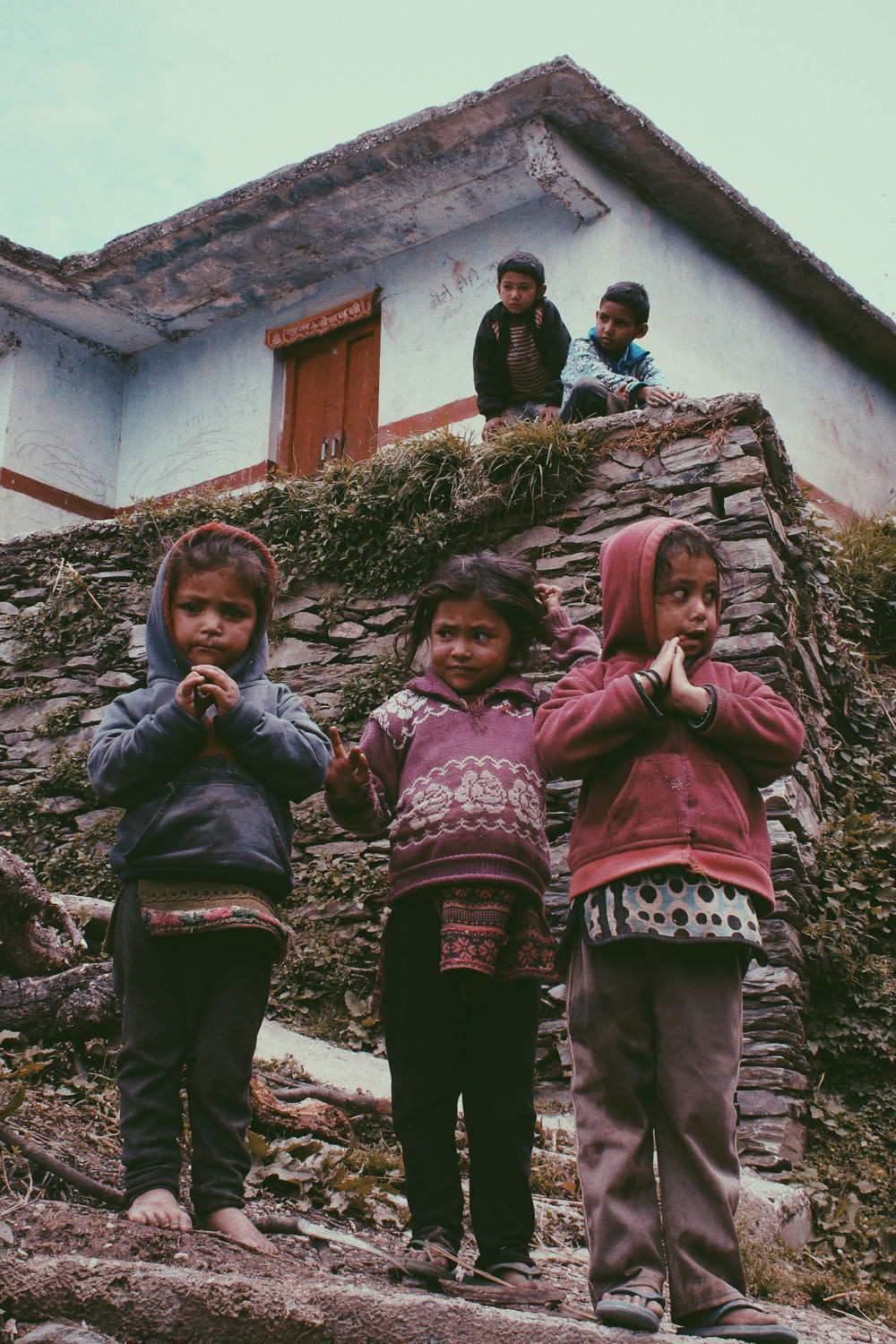 group of children standing near house