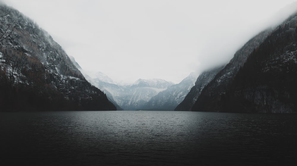 landscape photography of body of water against two mountains