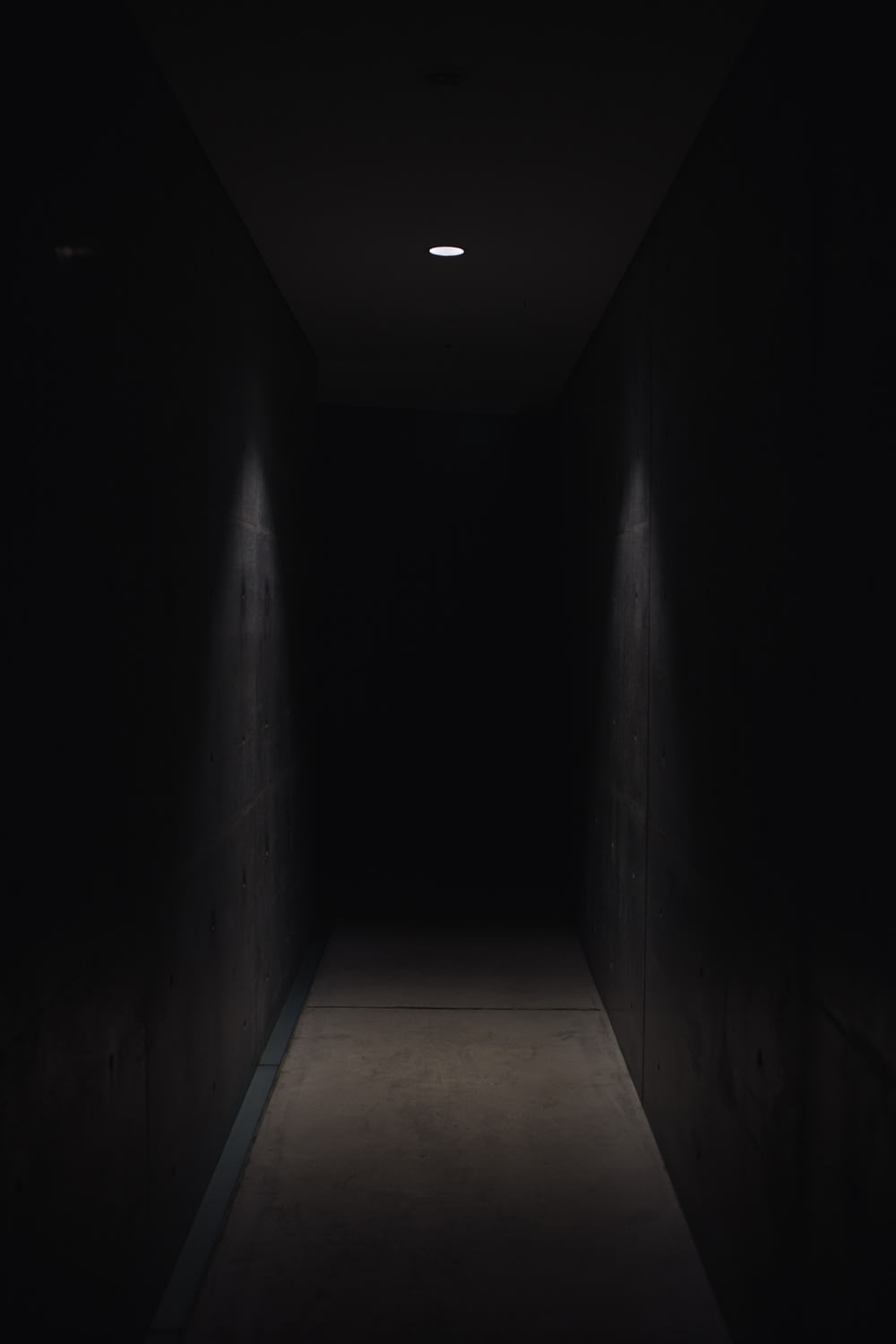 dark pathway lit with small light fixture