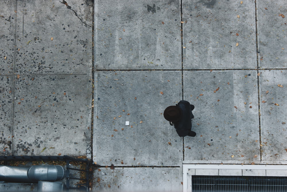 aerial photography of person standing near concrete building