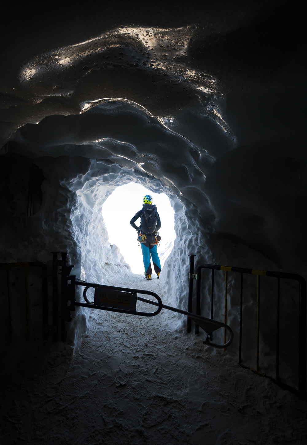a man standing in a tunnel in the snow