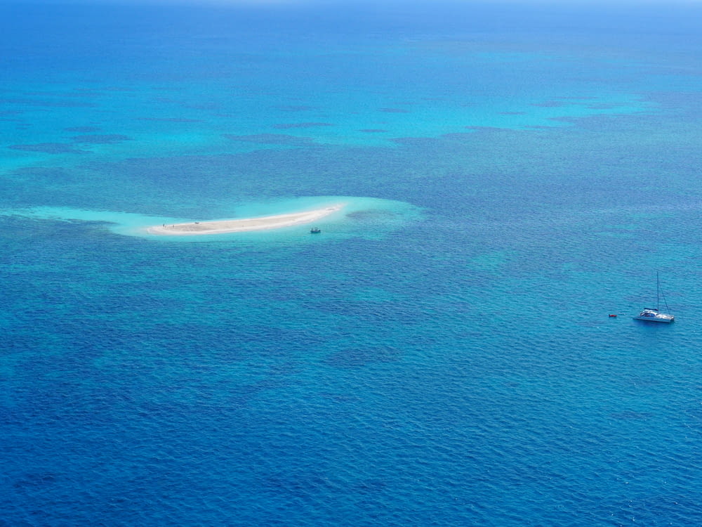 high-angle photography of boat near island