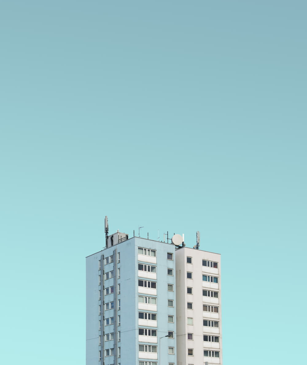 white painted high-rise building under clear sky