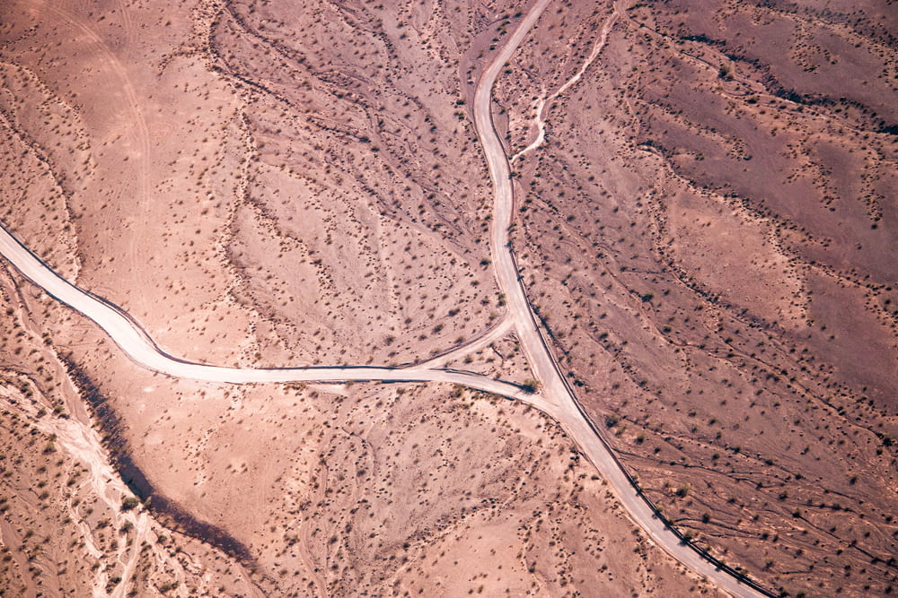 aerial photo of road on desert during daytime