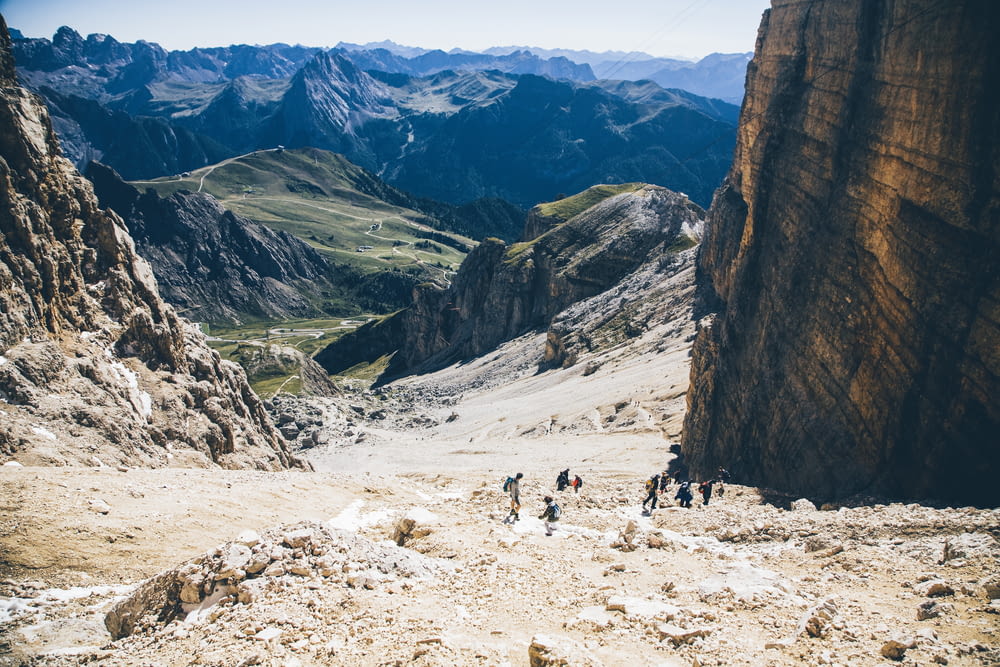 landscape photo of group of person walking on mountain