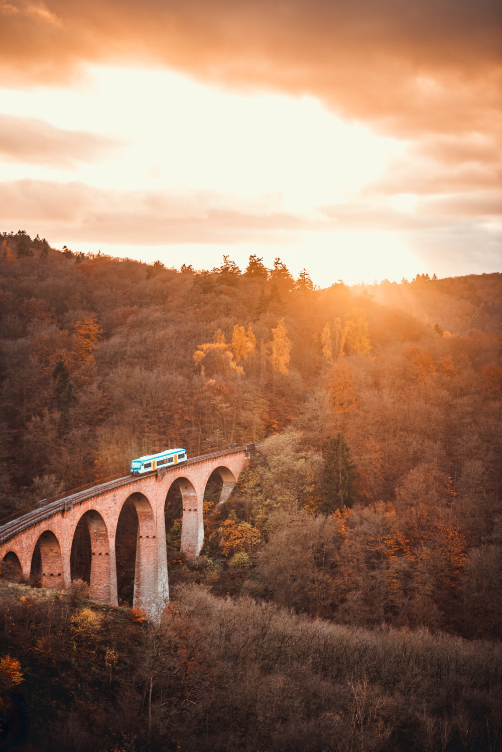 aerial view photography of train on bridge during sunset
