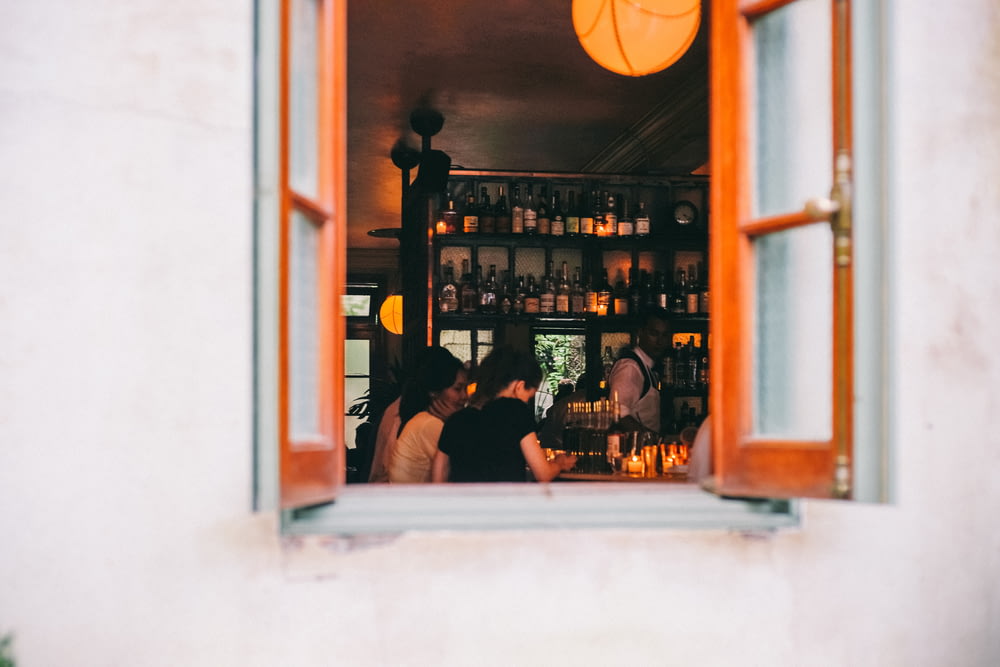 window of wine bar with people