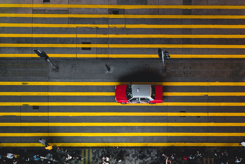 aerial photograph of gray and red car on street