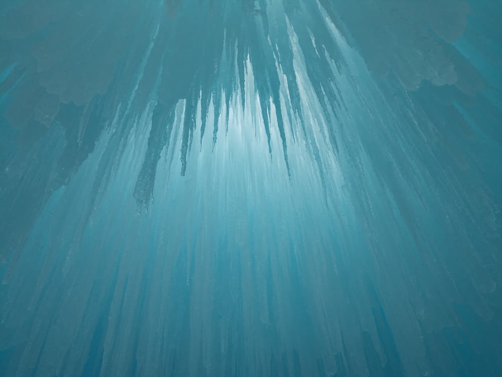 an underwater view of ice formations in the water
