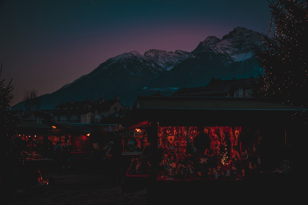 a night scene with a mountain in the background