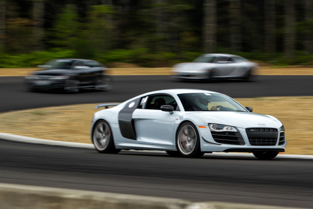 white Audi R8 driving on gray road