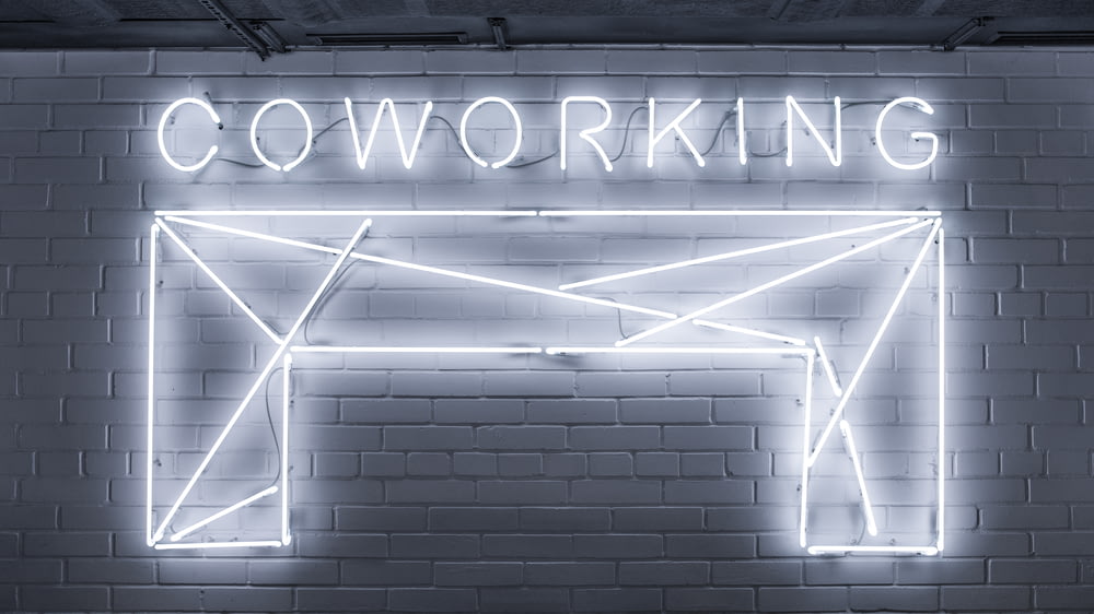 closeup photo of Co Working neon light sign