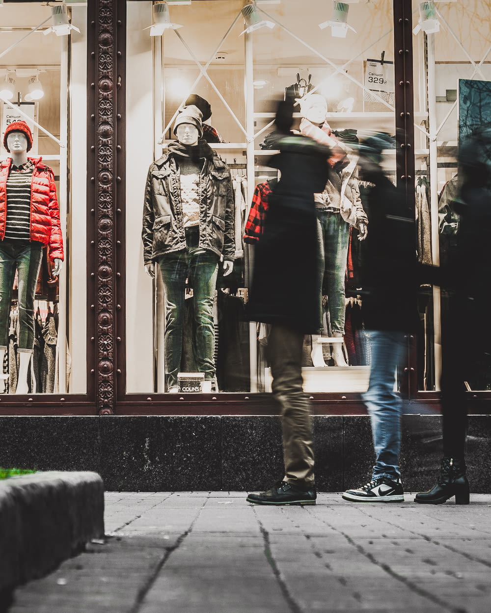 people watching manequins wearing jackets