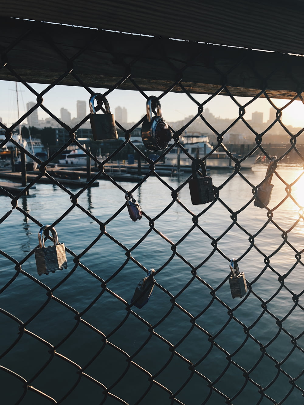 gray chain link with padlock over body of water