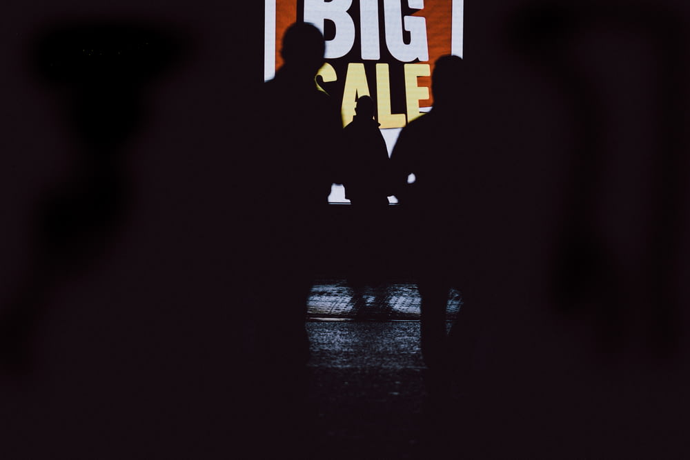 a man standing in front of a big sign