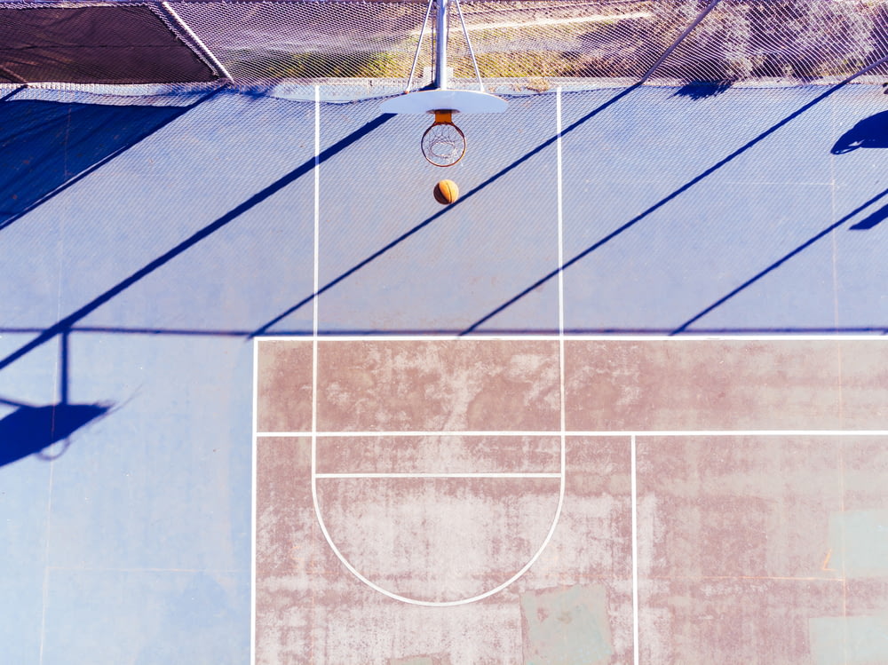 an overhead view of a tennis court with a ball on it