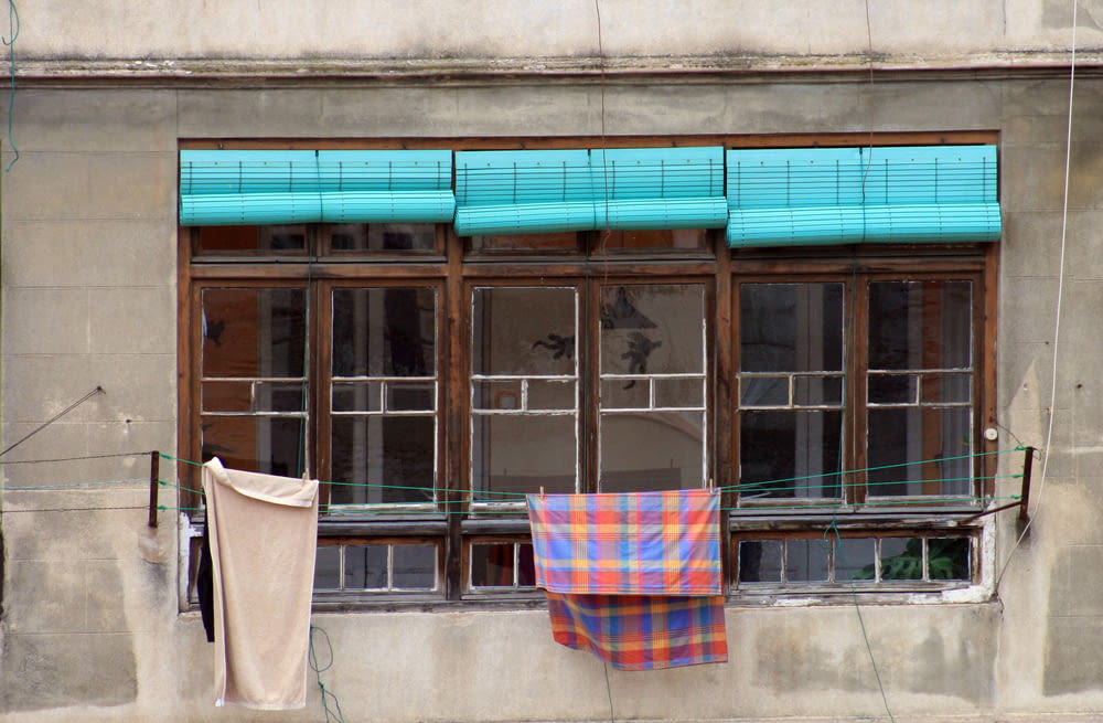 blue and red towel hanging near window