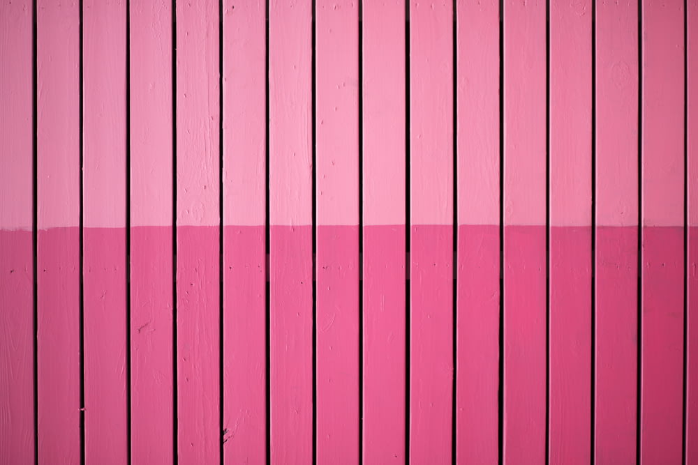 closeup photo of pink paint plank wall
