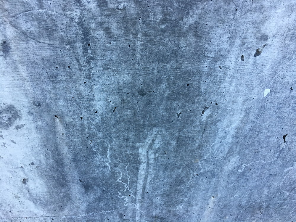 a close up of a cement wall with holes in it