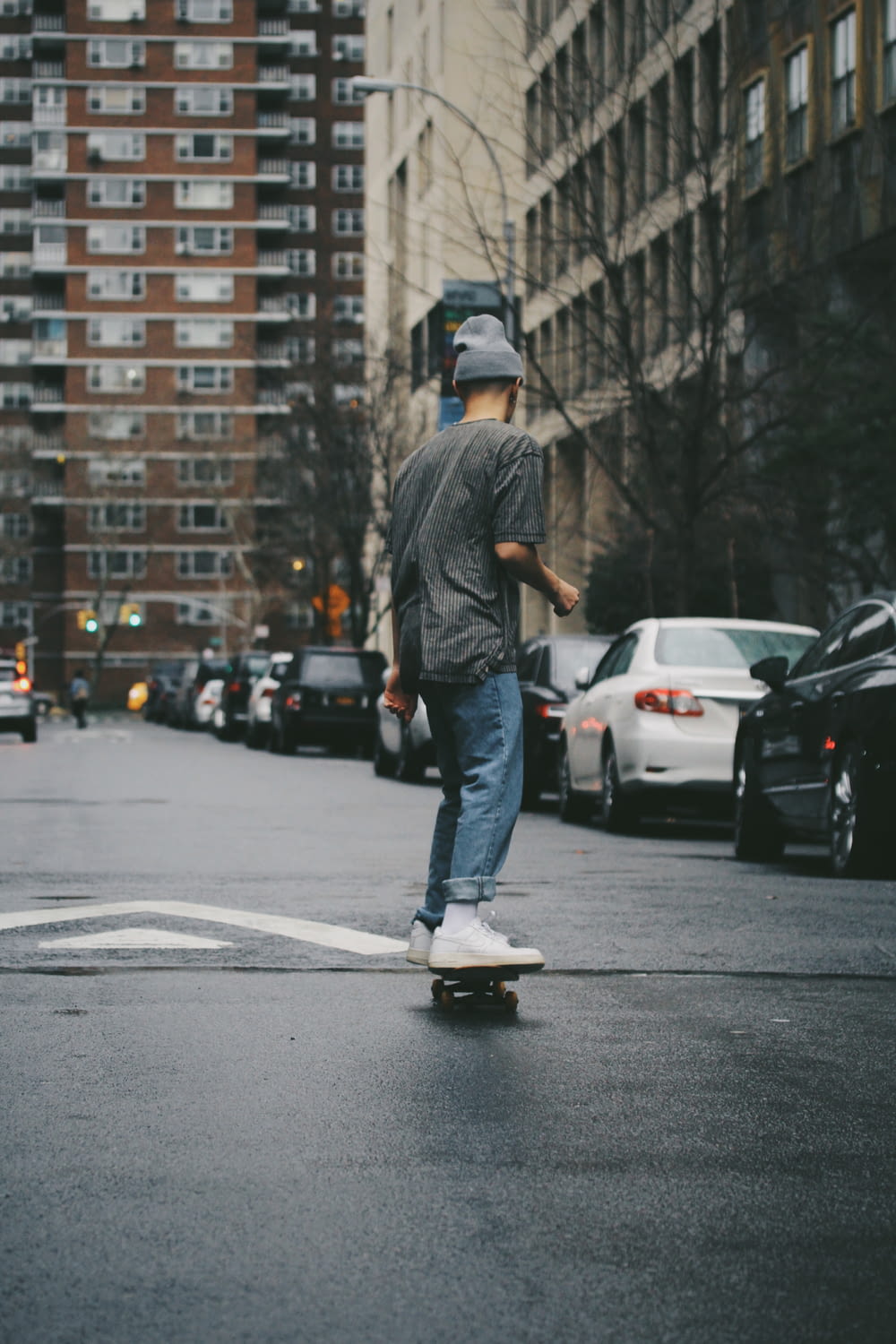 man riding skateboard near high rise building