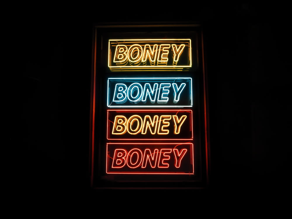 photo of yellow, blue, and red Boney neon sign