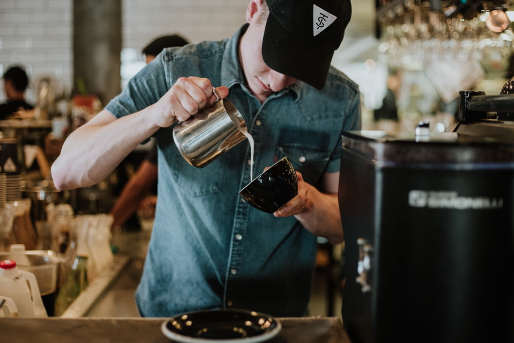 man making a coffee latte