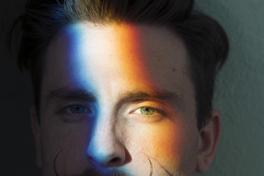 closeup photo of man's face with light reflections
