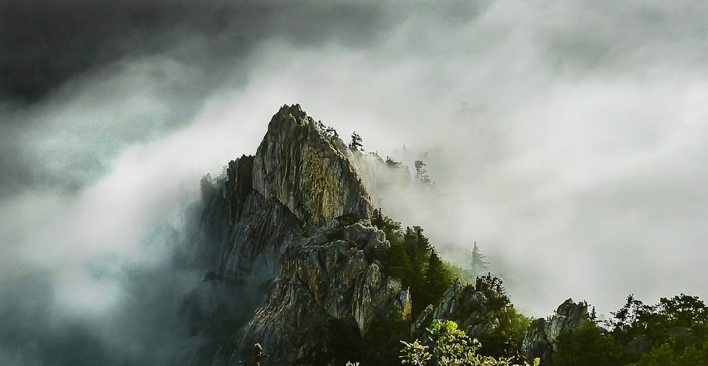 Montaña rocosa con nieblas durante el día