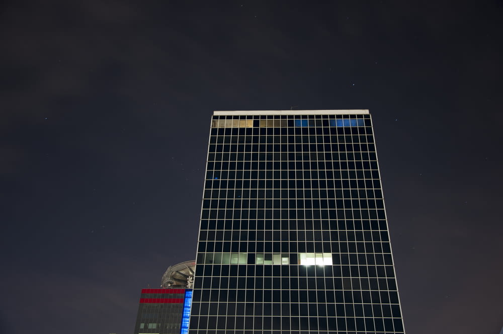 low-angle photo of high-rise building during night time
