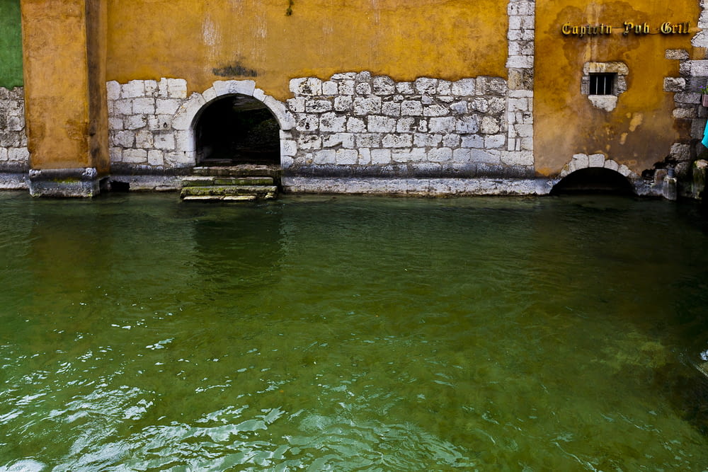 white and orange concrete structure beside body of water