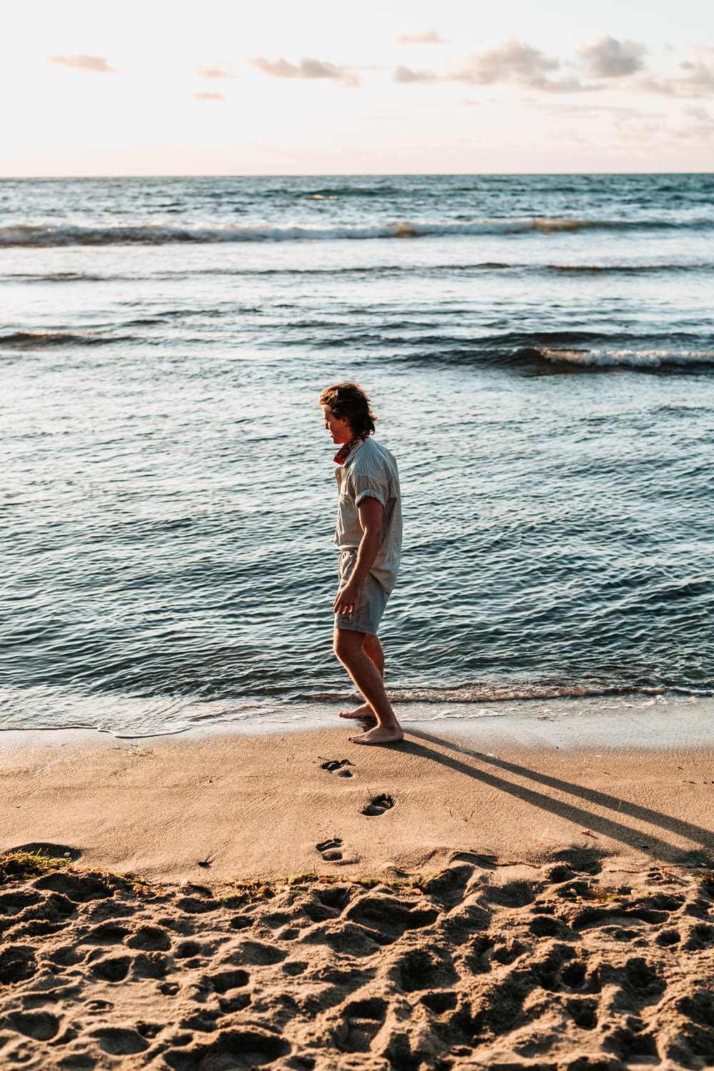 man standing on seashore