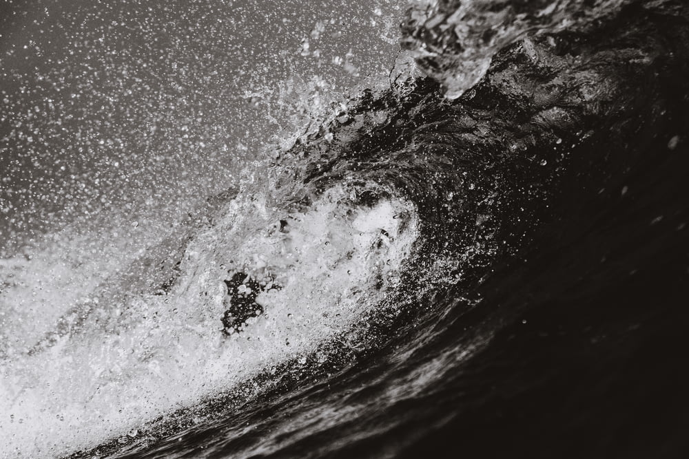 grayscale photo of barrel wave