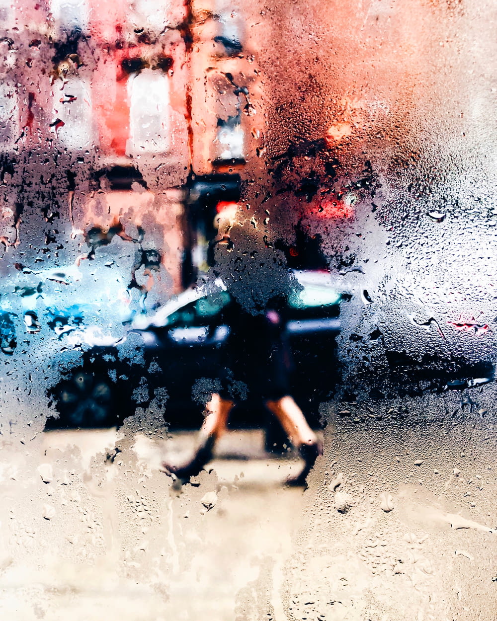 a blurry photo of a person walking in the rain