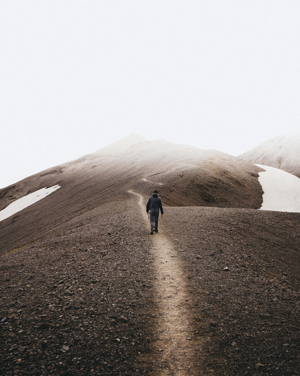man walking on mountain