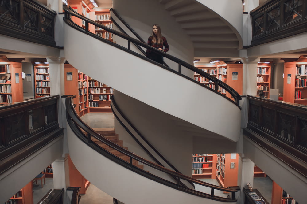 woman standing on spiral stairway