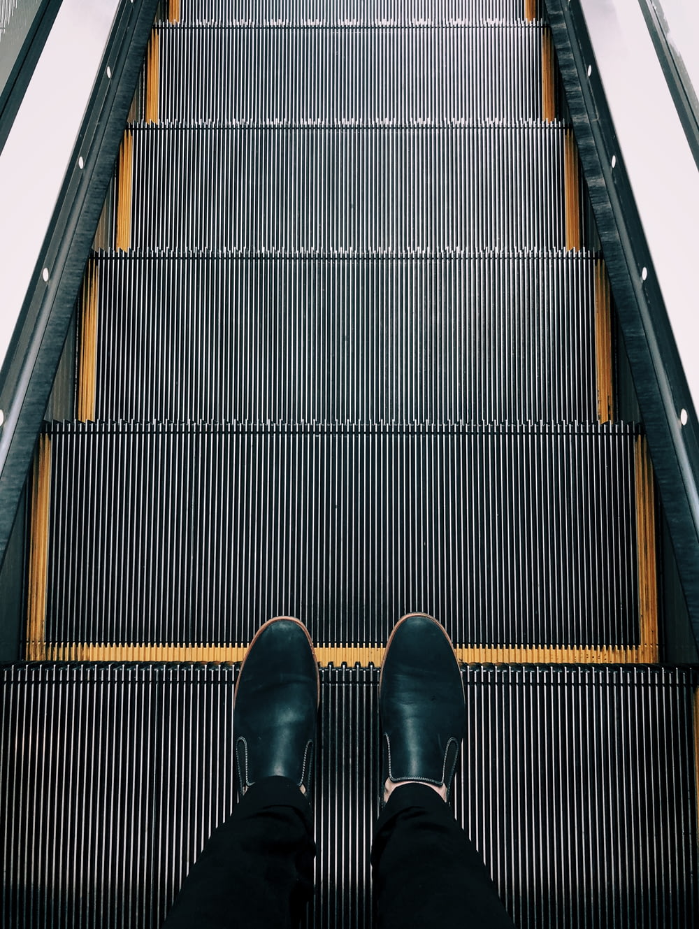 person standing on escalator