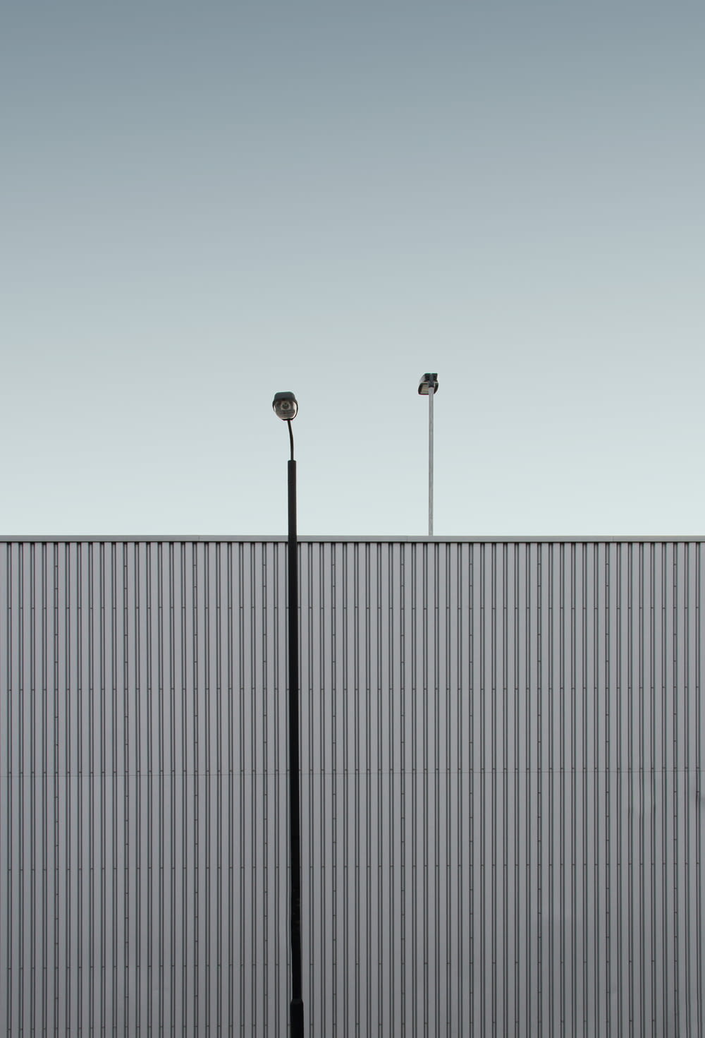 a couple of street lights sitting next to a tall building