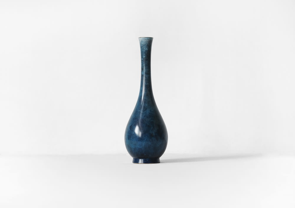 photography of blue ceramic vase against white background